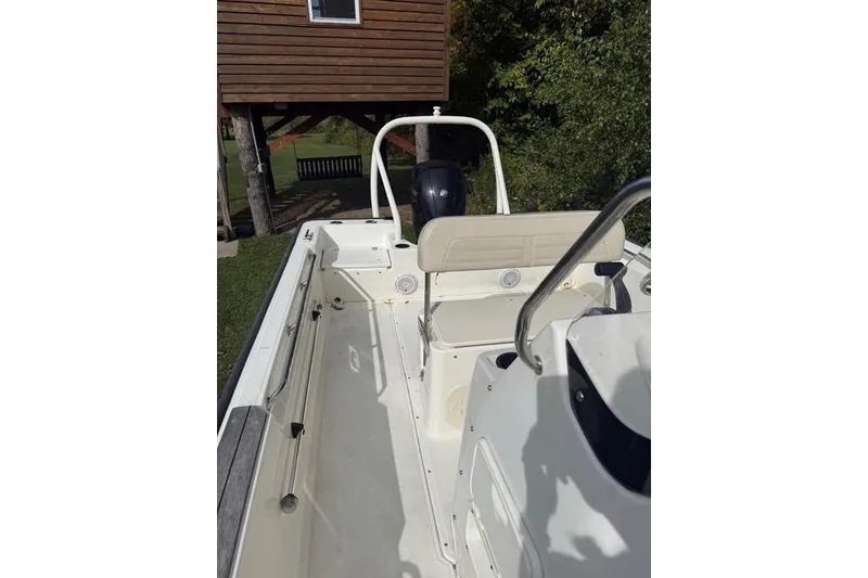 Slide: The Image of 2020 Boston Whaler 190 Montauk boat on trailer, parked near a house. - 4
