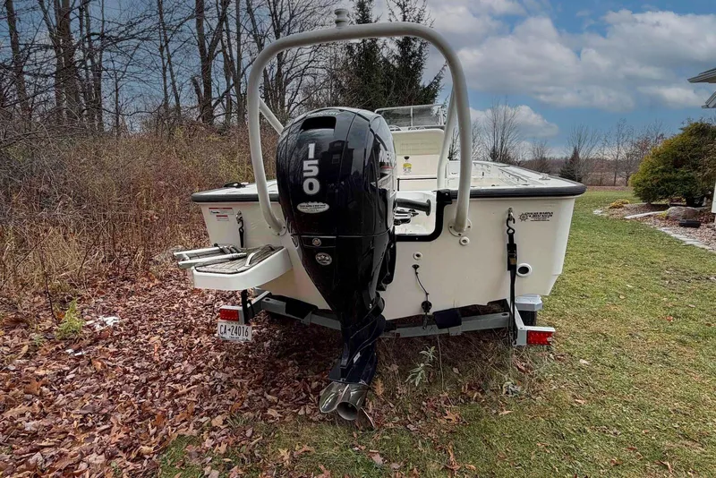 Slide: The Image of 2020 Boston Whaler 190 Montauk with 150 HP engine, parked on grass. - 9