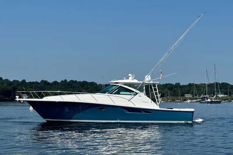 The Image of 2019 Tiara Yachts 4300 Open cruising on calm waters under clear blue sky. - 0