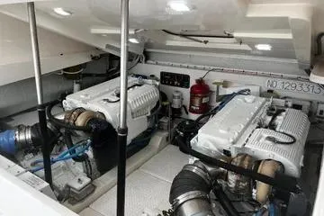 Slide: The Image of 2019 Tiara Yachts 4300 Open engine room with dual engines and safety equipment. - 11