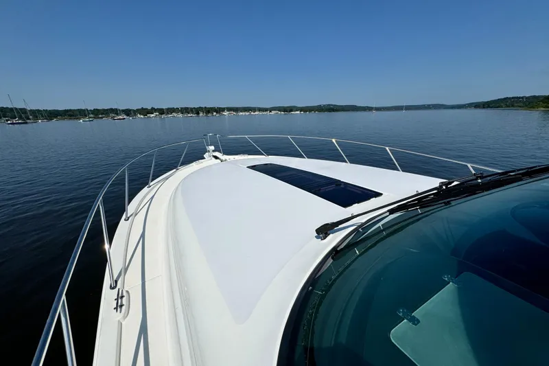 Slide: The Image of 2019 Tiara Yachts 4300 Open cruising on a calm lake under clear blue skies. - 12
