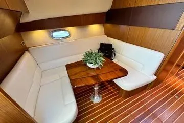 Slide: The Image of 2019 Tiara Yachts 4300 Open interior with elegant seating and wooden table. - 15