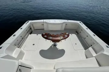 Slide: The Image of 2019 Tiara Yachts 4300 Open cockpit with fishing rod holders, on calm water. - 2