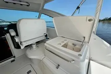 Slide: The Image of 2019 Tiara Yachts 4300 Open interior with helm seat and storage compartment. - 5