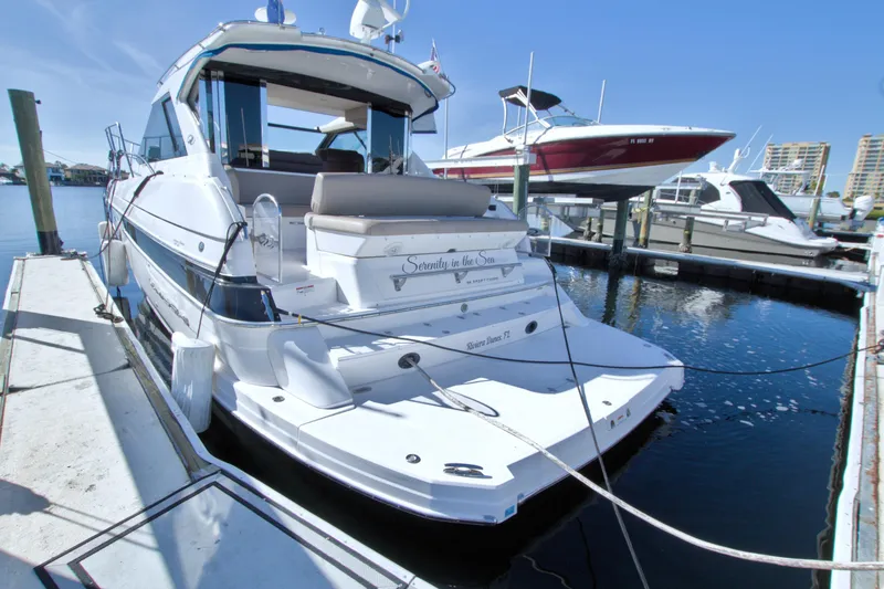 Slide: The Image of 2014 Regal 46 Sport Coupe yacht docked at marina under clear blue sky. - 10