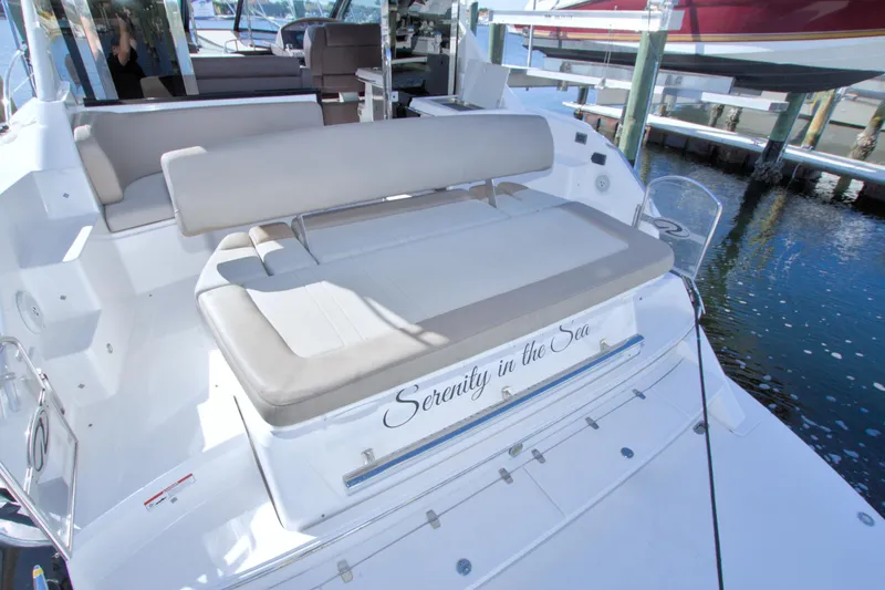 Slide: The Image of 2014 Regal 46 Sport Coupe yacht with "Serenity in the Sea" name, docked at marina. - 11
