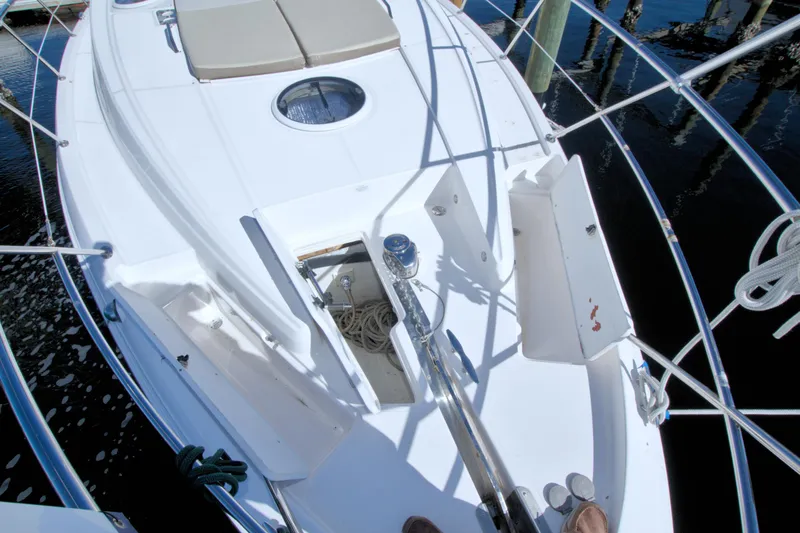Slide: The Image of 2014 Regal 46 Sport Coupe yacht deck with open storage compartment and railing. - 19