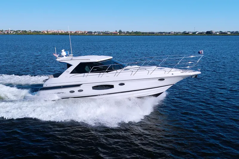 Slide: The Image of 2014 Regal 46 Sport Coupe cruising on open water, showcasing sleek design and performance. - 3