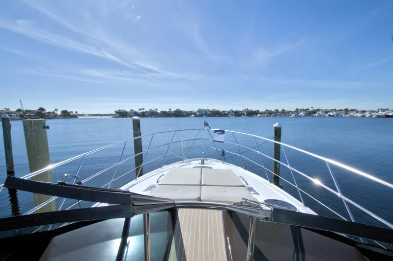 Slide: The Image of 2014 Regal 46 Sport Coupe yacht cruising on a sunny day, with clear blue skies. - 32