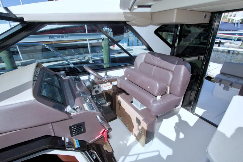 Slide: The Image of 2014 Regal 46 Sport Coupe helm with leather seating and modern controls. - 34