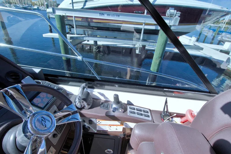 Slide: The Image of Interior view of 2014 Regal 46 Sport Coupe yacht cockpit with steering wheel and controls. - 35