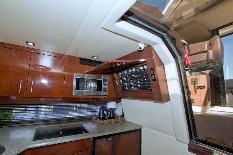 Slide: The Image of Interior of 2014 Regal 46 Sport Coupe yacht with modern kitchen and control panel. - 38
