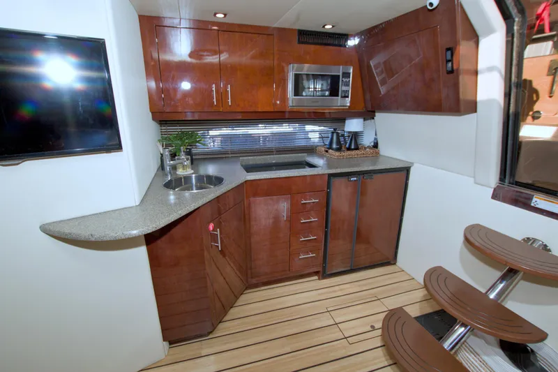 Slide: The Image of Luxurious 2014 Regal 46 Sport Coupe yacht kitchen with modern amenities and sleek design. - 39