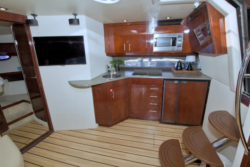 Slide: The Image of Luxurious interior of 2014 Regal 46 Sport Coupe yacht with modern kitchen amenities. - 40