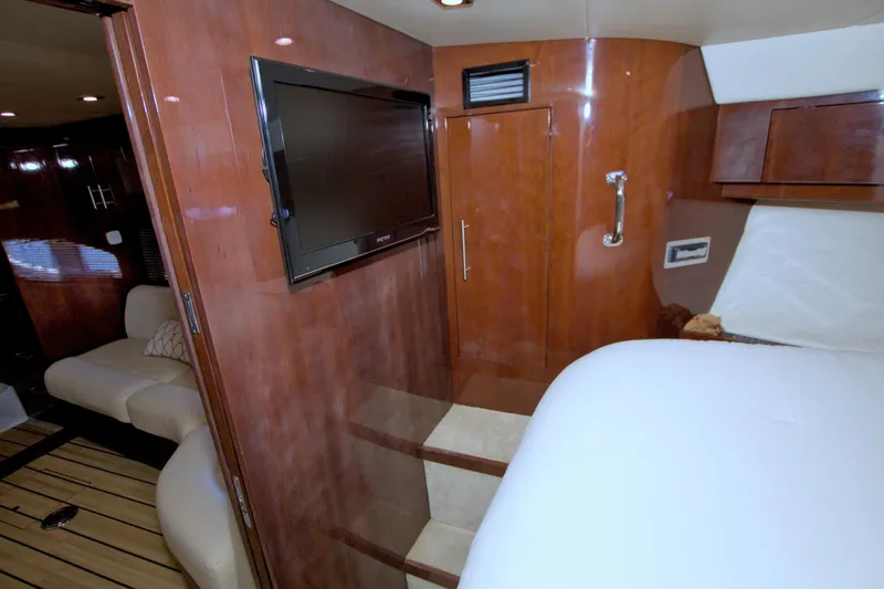 Slide: The Image of Interior of 2014 Regal 46 Sport Coupe with wood paneling and flat-screen TV. - 44