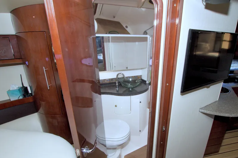 Slide: The Image of 2014 Regal 46 Sport Coupe bathroom with modern fixtures and wooden cabinetry. - 48