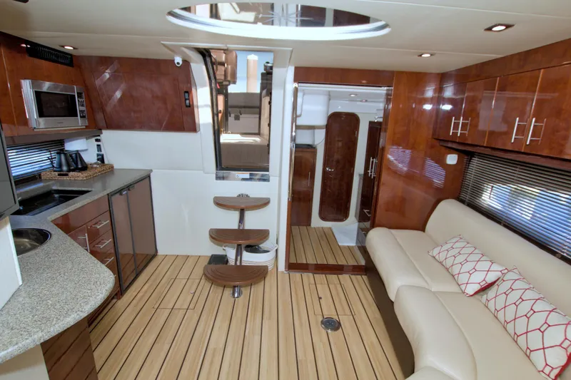 Slide: The Image of Luxurious interior of 2014 Regal 46 Sport Coupe yacht with modern kitchen and seating area. - 51