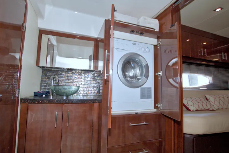 Slide: The Image of 2014 Regal 46 Sport Coupe interior with washer, sink, and modern cabinetry. - 57