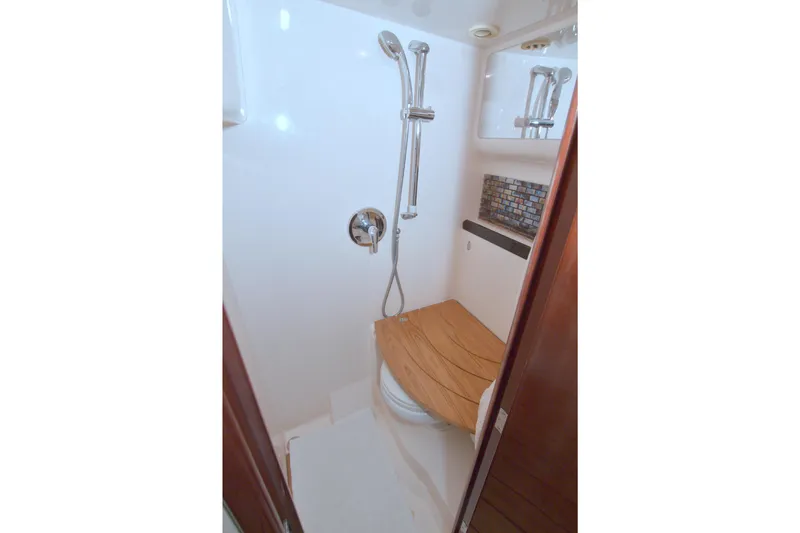 Slide: The Image of 2014 Regal 46 Sport Coupe shower with wooden seat and modern fixtures. - 59