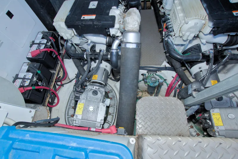 Slide: The Image of Engine room of a 2014 Regal 46 Sport Coupe with visible batteries and machinery. - 65