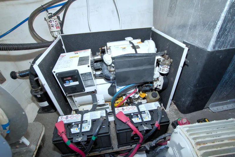 Slide: The Image of Engine room of 2014 Regal 46 Sport Coupe with generator and batteries. - 68