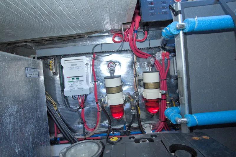 Slide: The Image of Engine room of 2014 Regal 46 Sport Coupe with wiring and filtration systems. - 70