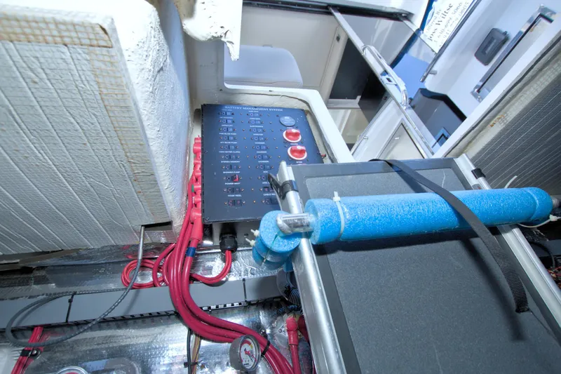 Slide: The Image of 2014 Regal 46 Sport Coupe battery management system with red cables and blue insulation. - 71