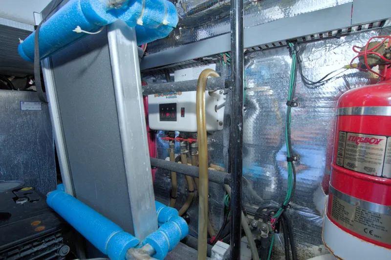 Slide: The Image of Engine room of 2014 Regal 46 Sport Coupe with fire extinguisher and control panel. - 72