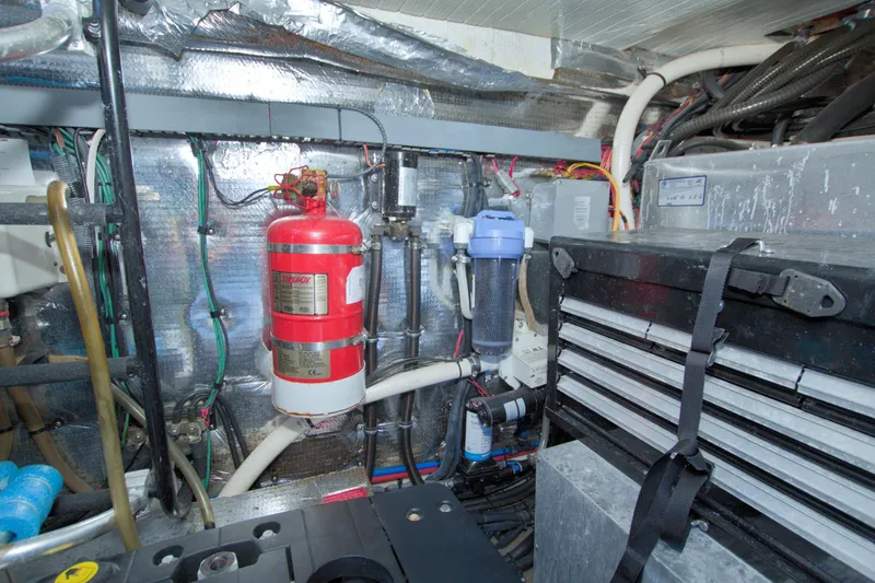 Slide: The Image of Engine room of 2014 Regal 46 Sport Coupe with fire extinguisher and tool storage. - 73