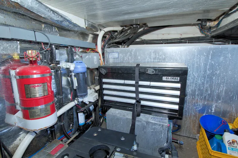 Slide: The Image of Engine room of 2014 Regal 46 Sport Coupe with toolbox and fire extinguisher. - 74
