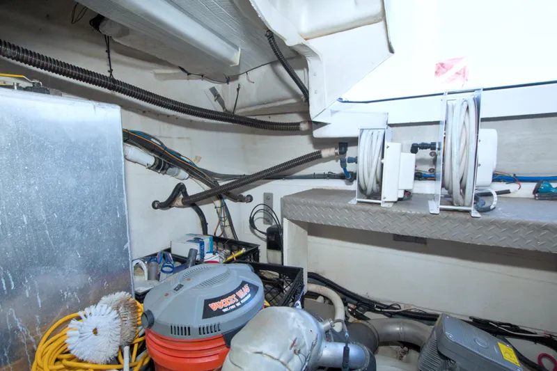 Slide: The Image of Engine room of 2014 Regal 46 Sport Coupe with hoses and equipment. - 75