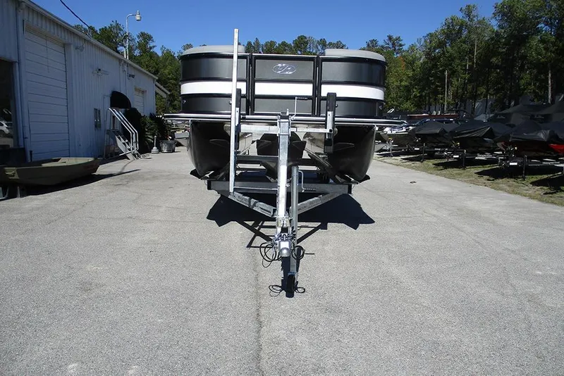 Slide: The Image of 2026 Bentley Pontoons Legacy 243 Swingback on trailer, parked outdoors near a building. - 4