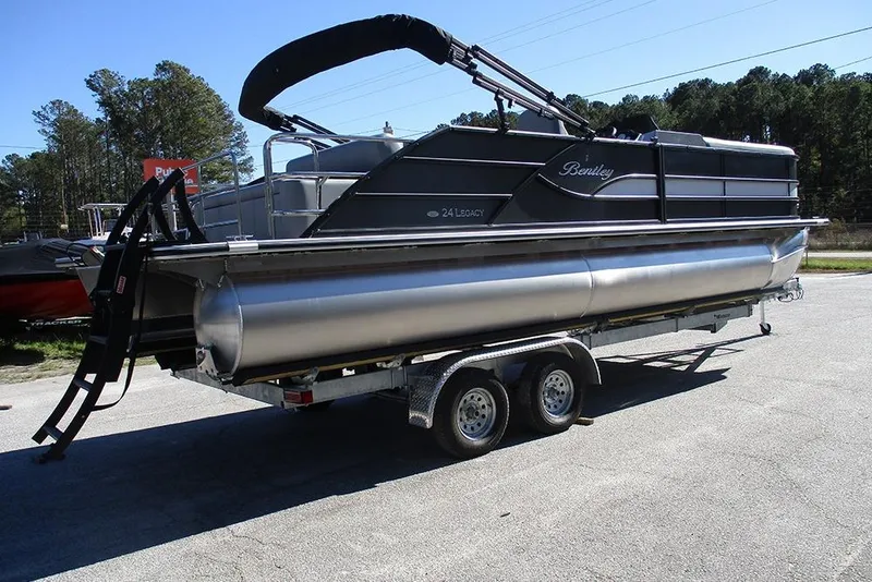 Slide: The Image of 2026 Bentley Pontoons Legacy 243 Swingback on trailer, parked outdoors. - 7