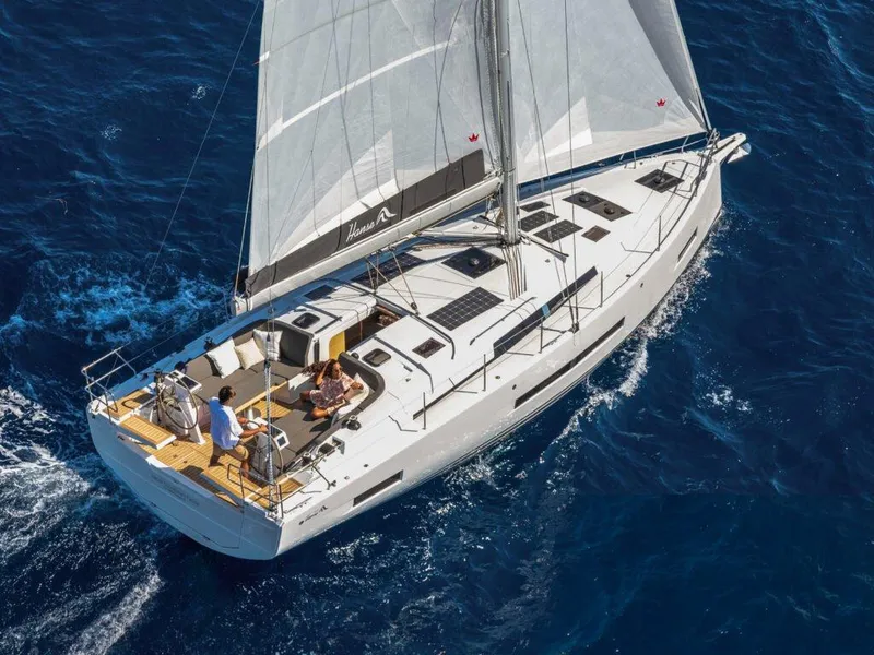 The Image of 2025 Hanse 410 sailboat cruising on open blue sea, aerial view. - 0