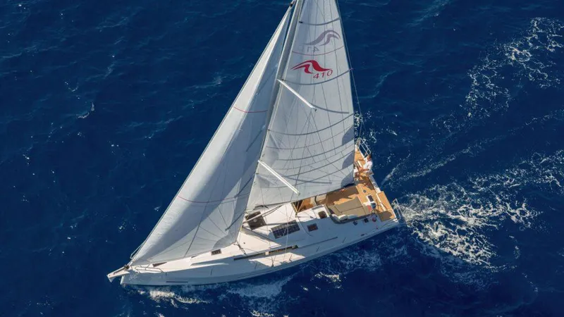 Slide: The Image of Aerial view of 2025 Hanse 410 sailboat navigating deep blue ocean waters. - 14