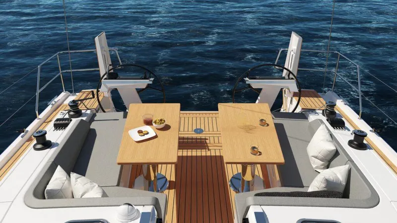 Slide: The Image of Luxurious 2025 Hanse 410 yacht deck with elegant seating and tables, overlooking the ocean. - 17