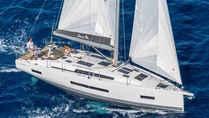 Slide: The Image of 2025 Hanse 410 sailboat navigating blue ocean waters, showcasing sleek design and spacious deck. - 2