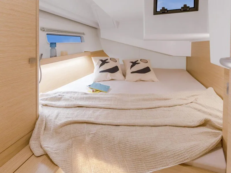 Slide: The Image of Cozy cabin interior of 2025 Hanse 410 yacht with bed and decorative pillows. - 21