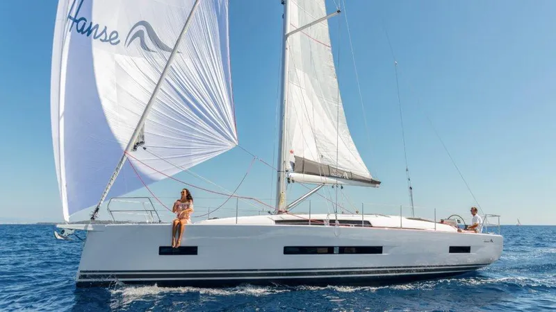 Slide: The Image of 2025 Hanse 410 sailboat cruising on open sea under clear blue sky. - 6