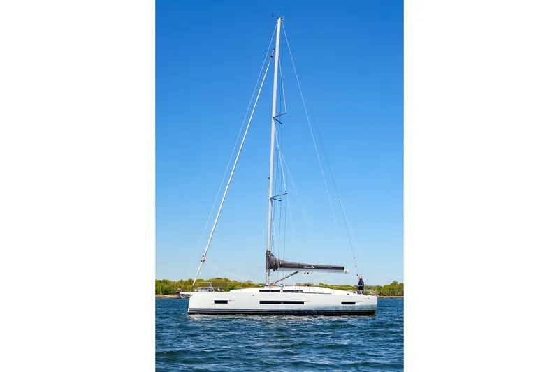 The Image of 2025 Hanse 410 sailboat on calm water under clear blue sky. - 4