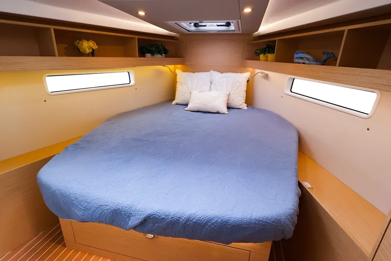 Slide: The Image of Luxurious cabin interior of 2025 Hanse 410 yacht with cozy bed and modern decor. - 13
