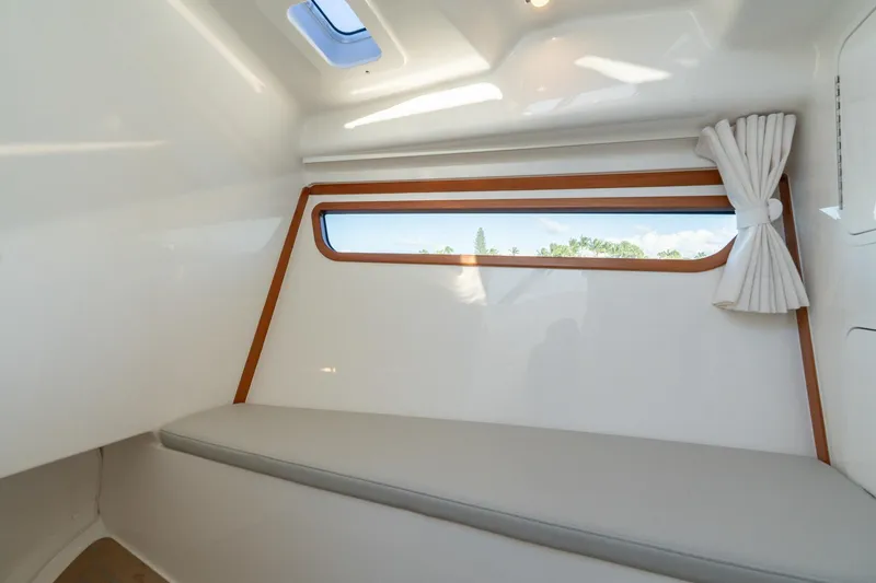 Slide: The Image of Interior cabin of 2026 MJM 3 boat with window and seating. - 4