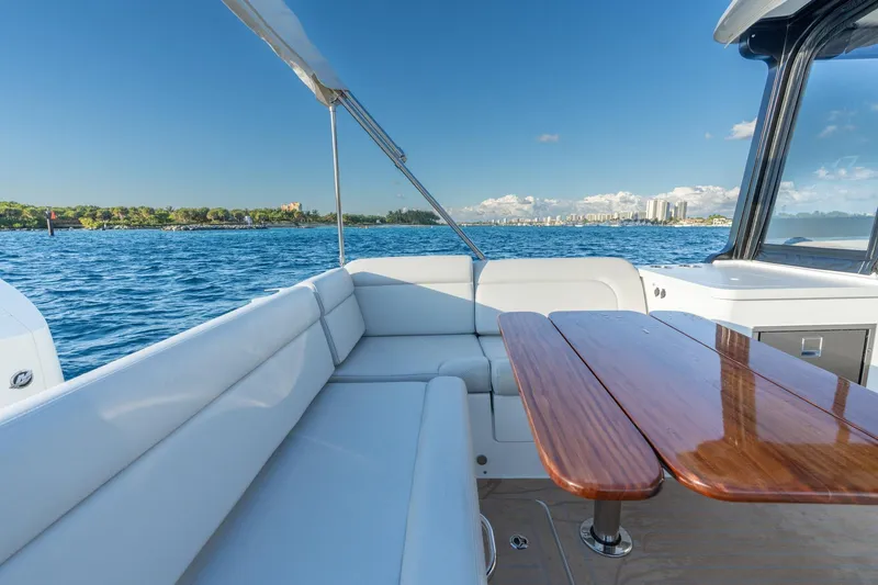 Slide: The Image of Luxurious MJM 3 boat interior, 2026 model, with elegant seating and wooden table on open water. - 8