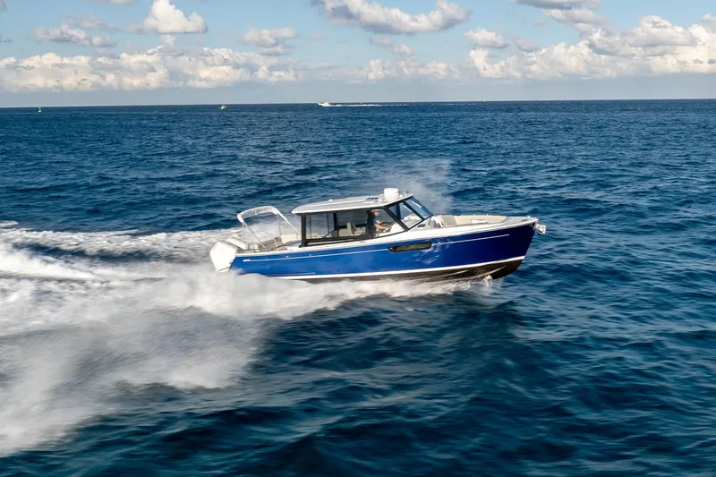 Slide: The Image of 2026 MJM 3 boat cruising on open ocean under clear skies. - 1