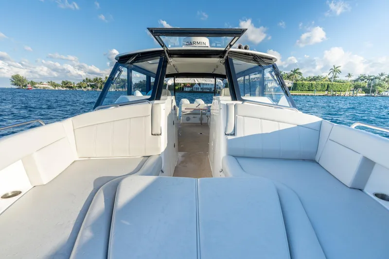 Slide: The Image of Luxury MJM 3 boat cruising on a sunny day, 2026 model, with spacious seating. - 11