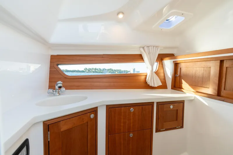 Slide: The Image of Luxurious interior of 2026 MJM 3 boat with wooden cabinets and scenic window view. - 6