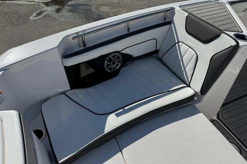 Slide: The Image of 2024 Yamaha Boats 255 FSH Sport H interior seating with speaker and cup holder. - 16