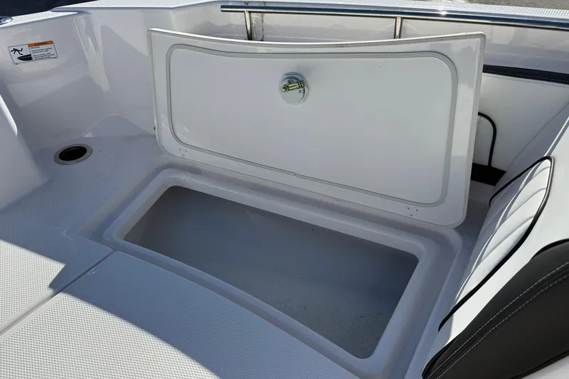 Slide: The Image of 2024 Yamaha Boats 255 FSH Sport H storage compartment, open and empty. - 20