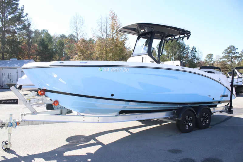 Slide: The Image of 2024 Yamaha Boats 255 FSH Sport H on trailer, side view, outdoors. - 4