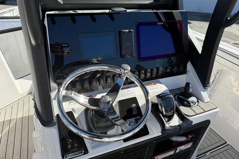 Slide: The Image of 2024 Yamaha Boats 255 FSH Sport H dashboard with steering wheel and controls. - 7